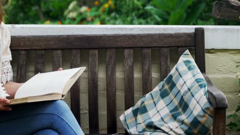 Mature-woman-reading-a-book-in-the-garden-4k