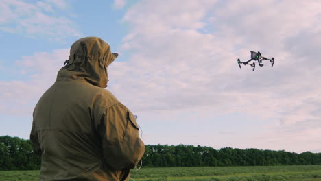 the man controls the drone the drone is flying high in the sky the camera follows the drone