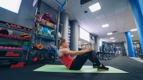 Attractive fit woman works out. Fitness girl performing exercises at gym