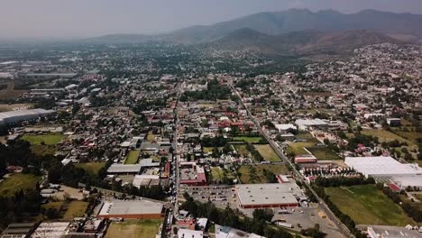 aerial panoramic drone shot of the urban settlement of the pueblo mágico of tepotzotlán, part of the metropolitan area of mexico city, with the surrounding sierra in the background