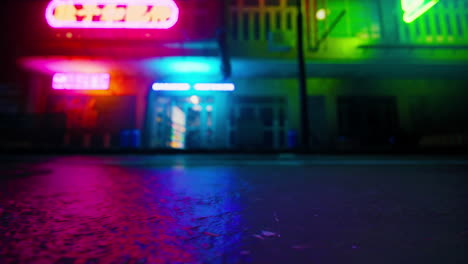 neon lights reflecting in wet pavement at night