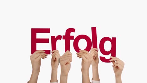 Woman-hand-holding-word-ERFOLG