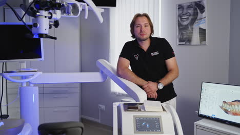 talking male dentist in dental office. dentist talking on camera in dental clinic