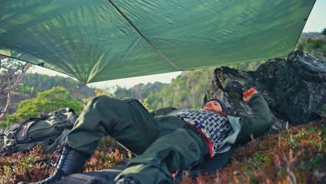 man lying during hike in mountains - close up