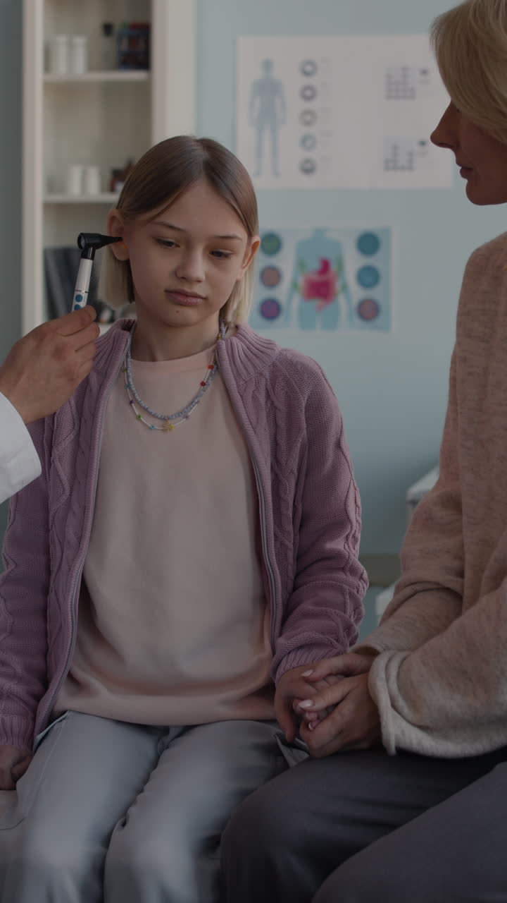 Doctor examining a child's ear