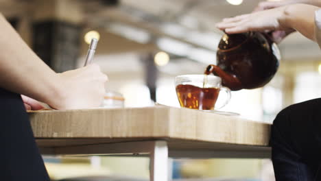 close up hands showing business plan in cafe