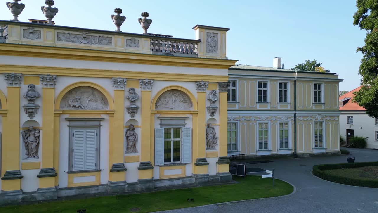 Drone captures Warsaw’s Wilanów Palace in sunlight and shadow, highlighting baroque architecture, expansive gardens, and cultural heritage landmark in Poland