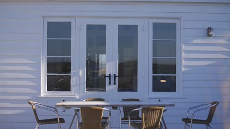 white-holiday-home-outside-with-tables-and-chairs