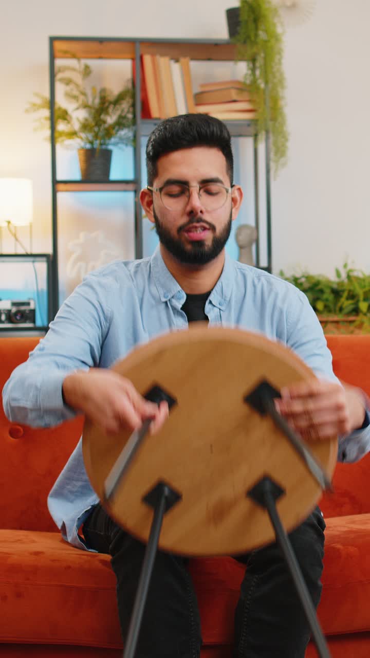 Happy indian man finishing assembling furniture table desk collect repair fixing at home apartment