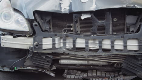 detail of car damaged in motor vehicle accident parked in garage repair shop