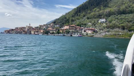 view from side of boat of monte isola village in iseo lake