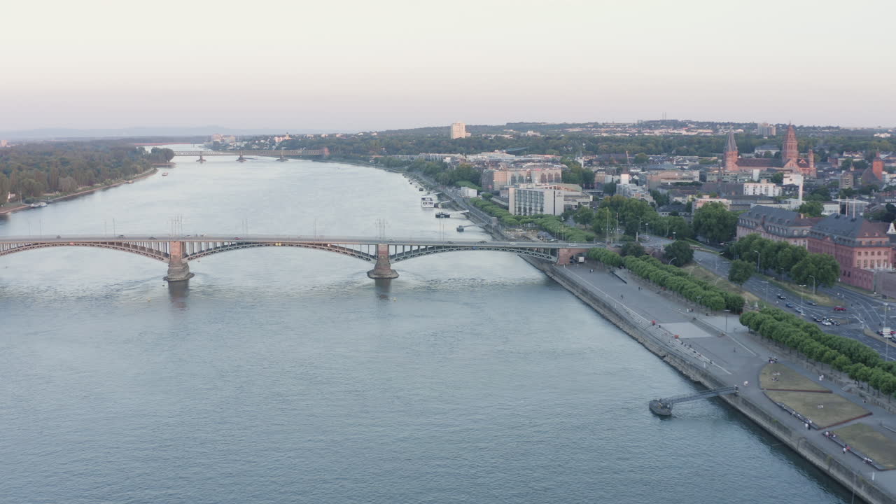 Aerial approach drone View of Mainz ship Rhine River, Castle, dom, Theodor Heuss Bridge and Cityscape at Sunset Germany 4k