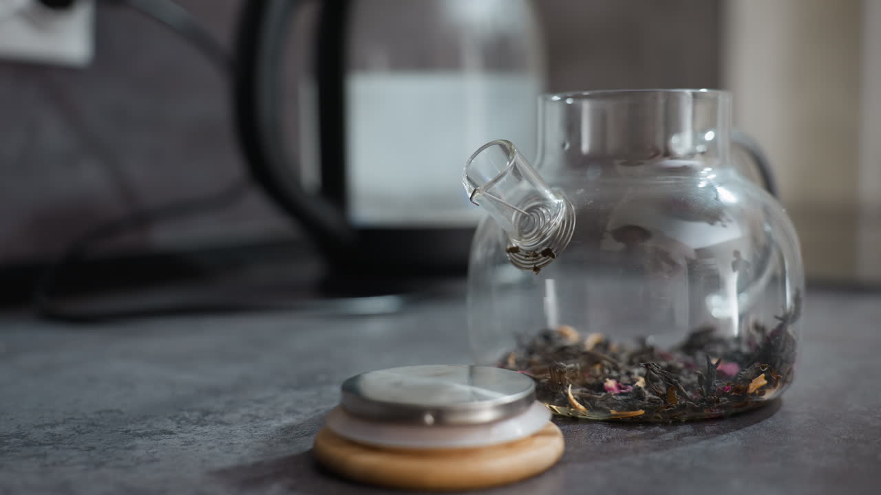 Serene Glass Teapot With Tea, Peaceful Setting Featuring Glass Teapot And Loose Leaves, Tranquil Environment Showcasing Delicate Glass Teapot Filled With Fresh Brewed Loose Leaf Tea