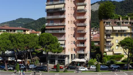 aerial ascend on apartment buildings in italian village with mountain landscape