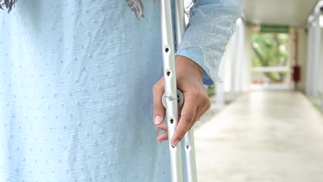 young man with broken leg on crutches