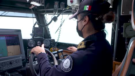 Mexican marines sailing and driving at the bridge of a a patrol boat