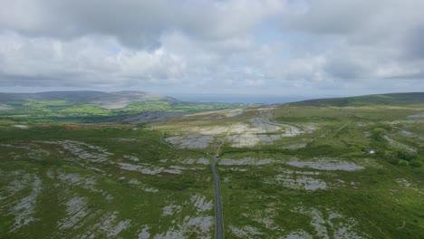 The-uplands-of-the-Burren,-a-road-leads-to-the-sea