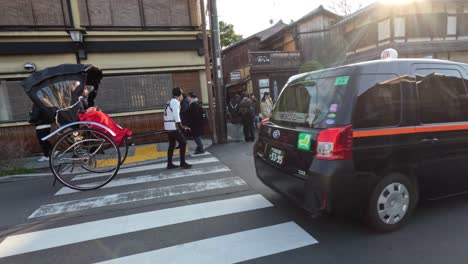 pedestrians, vehicles, and rickshaw crossing busy intersection