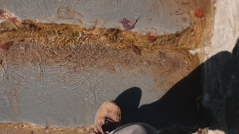 hiker climbs steps covered in water