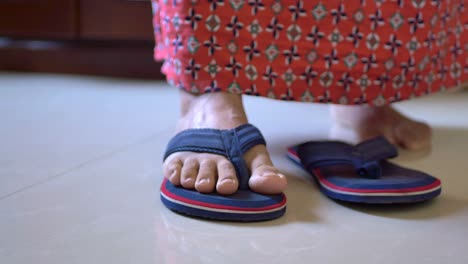 woman wearing flip-flops and a red skirt