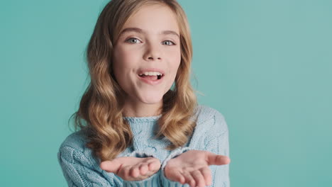 happy teenage caucasian girl sending kisses in front of the camera.