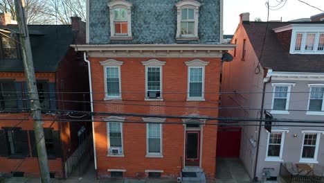 Aerial-rising-shot-of-American-city-house-with-trash-on-curb