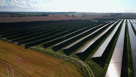 large field of photovoltaic solar panels - aerial drone shot