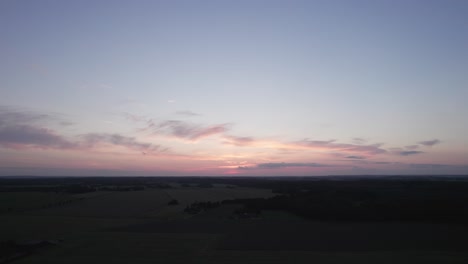 flyover view from above of the danish countryside fields and forest - dolly shot