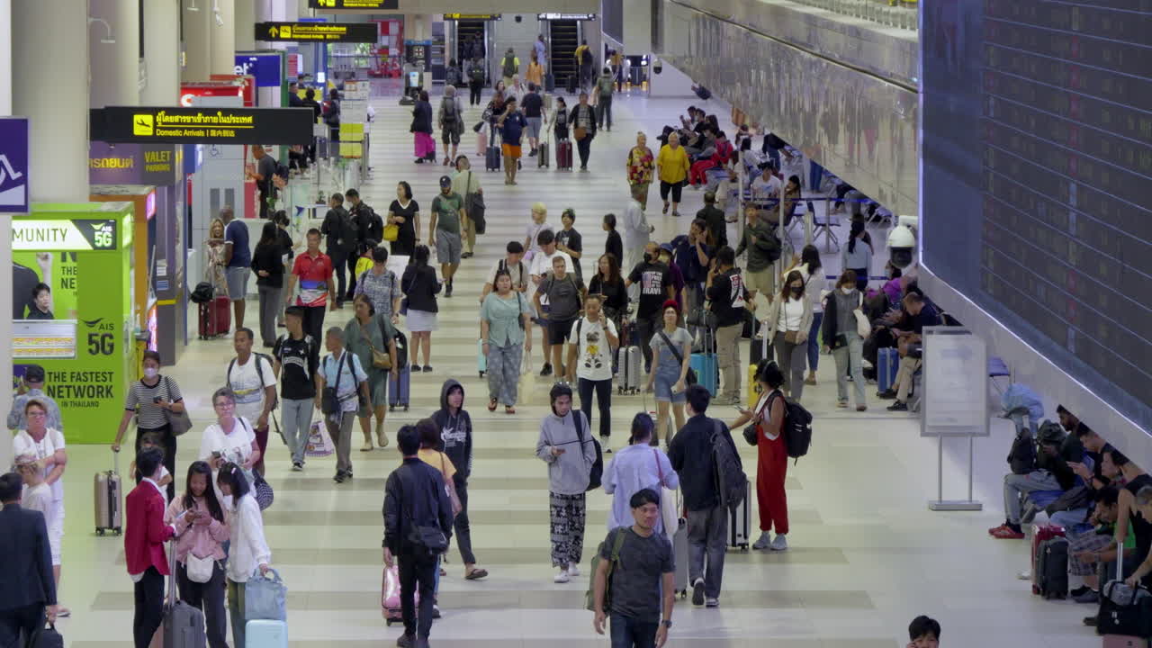 Busy Airport Terminal: Crowds of Travelers Walking Through Departure Area