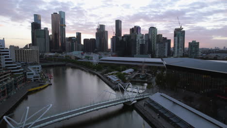 drone passing convention centre, toward skyscrapers of southbank, melbourne