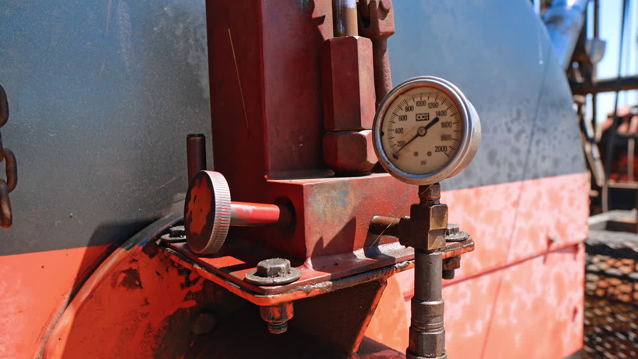 Male hand turning the round handle on the equipment with sensor. Setting the machines for drilling oil. Close up.