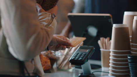 happy barista man serving customers in cafe using credit card making payment buying coffee spending money enjoying service