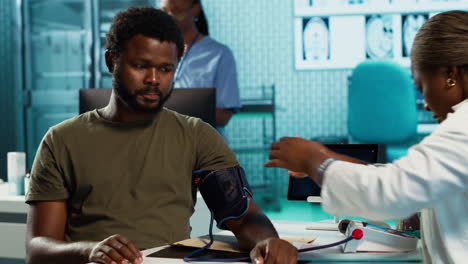 general practitioner measuring blood pressure with a blood pressure monitor