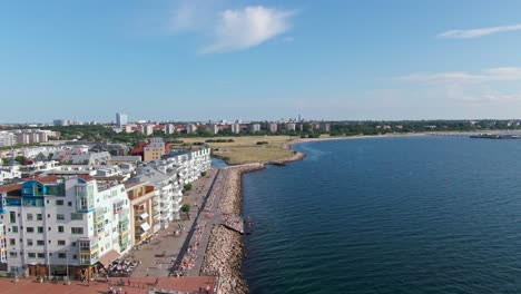 Aerial-shot-of-the-busy-dock-in-Västra-hamnen,-moving-towards-Ribersborg,-Malmö-Sweden