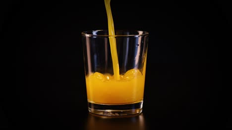 orange juice being poured into a glass