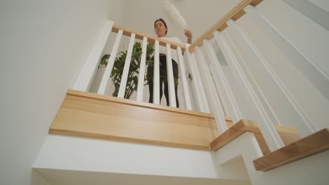 a beautiful pregnant woman tidying her home, engaged in household chores. the scene captures domestic life, maternity, and the balance of routine and preparation during pregnancy