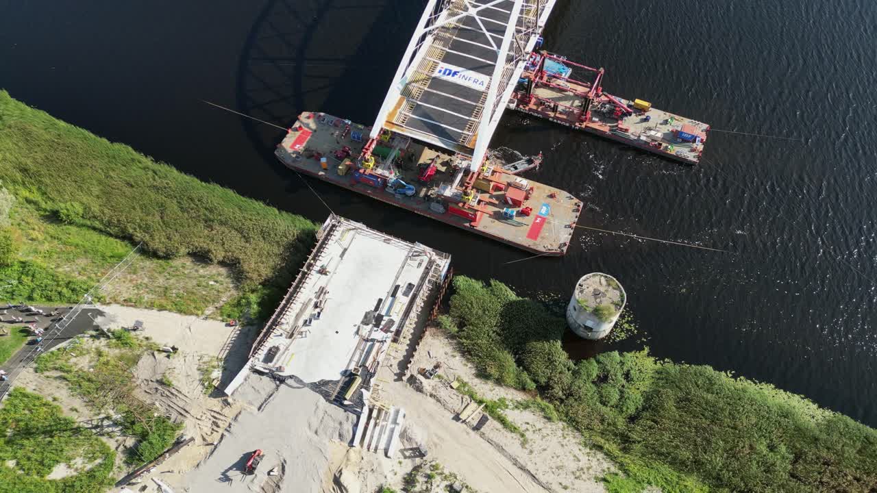 Heavy duty barge pulls new arch bridge into position over Parnu River