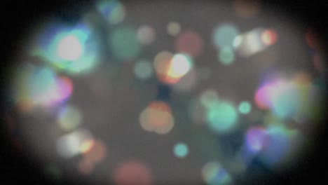 animation of multiple out of focus spots of light and shimmering particles