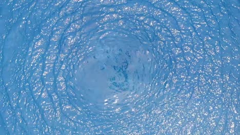 aerial view of pool water rippling in slow motion