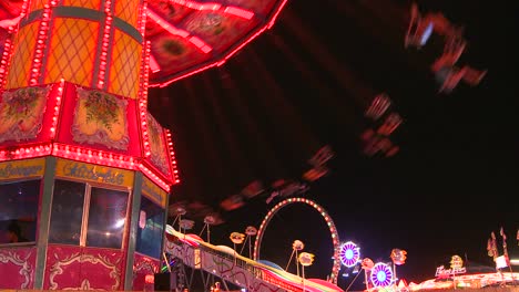 swings at a carnival at night