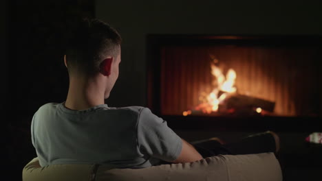 man relaxing by the fireplace