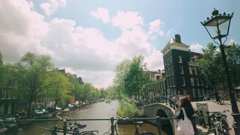 a scenic view of amsterdam's canals and bridges on a sunny day.