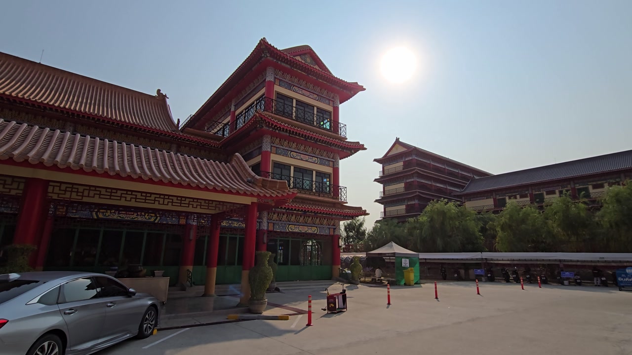 Chinese Temple Building with Sunlight Beaming Overhead in Thailand