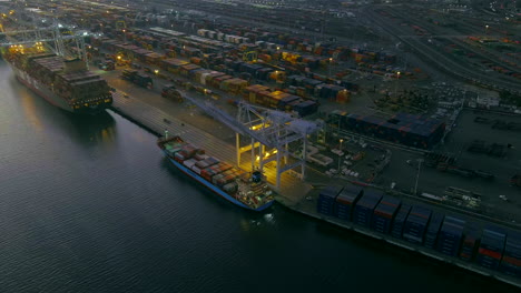 Aerial view of cranes unloading container ship in the port at night, Oakland USA