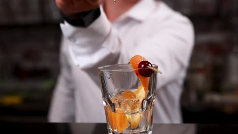bartender preparing an old fashioned cocktail