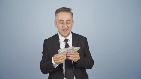 businessman counting money looking at camera.