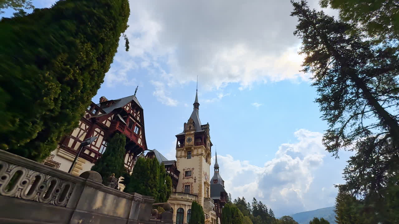 Sinaia, Romania, 17 luglio 2025: persona che si avvicina alla facciata dello splendido Castello di Peleș a Sinaia, in Romania. Veduta dal basso dell'edificio storico