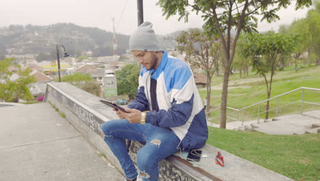 young boy using tablet outdoors