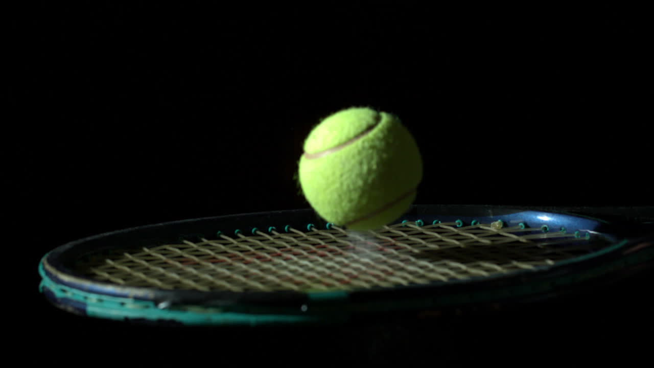 Tennis ball bouncing on a racket
