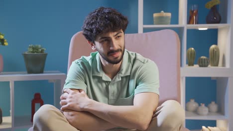 depressed and mentally ill young man crying alone at home.